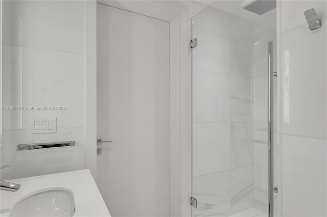 bathroom with sink and an enclosed shower