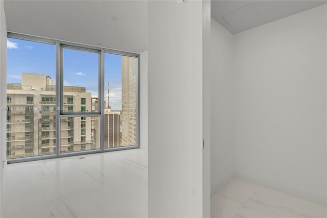 interior space featuring plenty of natural light and a wall of windows