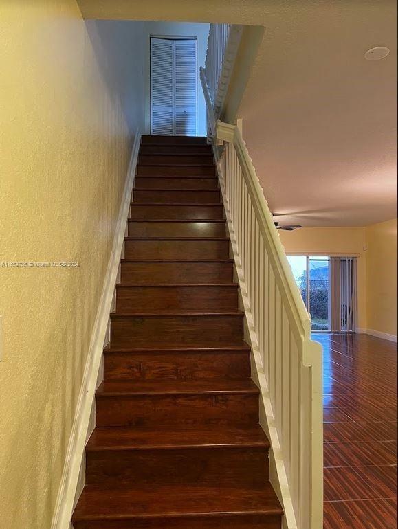 stairs featuring baseboards and wood finished floors