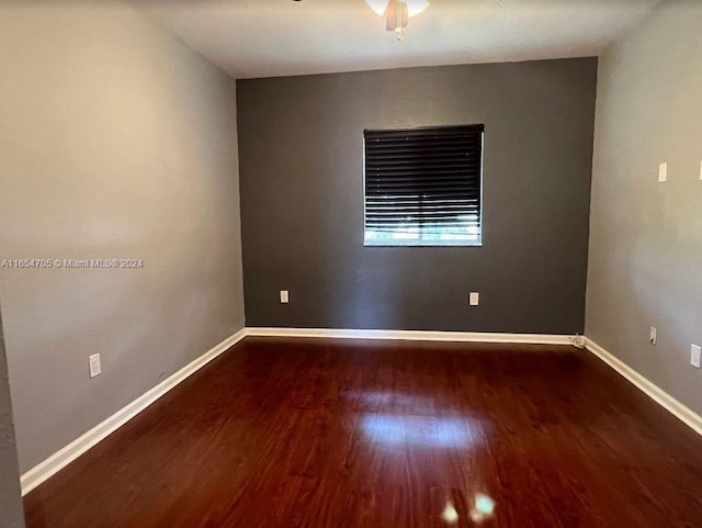 unfurnished room featuring wood finished floors, baseboards, and ceiling fan