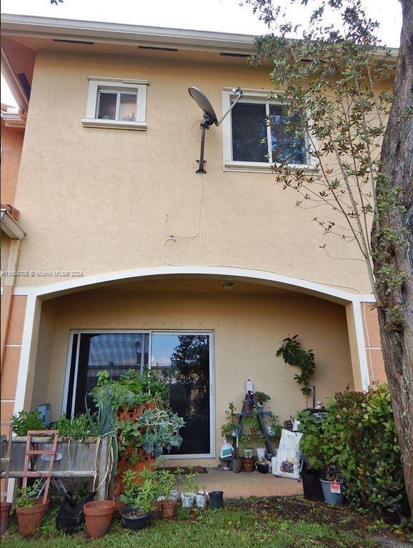 rear view of house with stucco siding