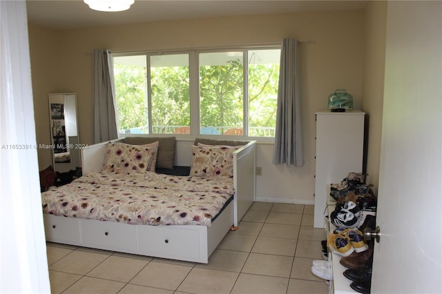 bedroom with multiple windows and light tile patterned floors