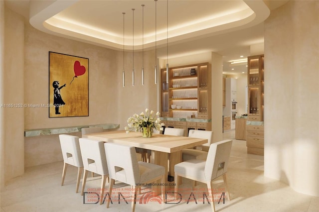 dining area featuring a raised ceiling