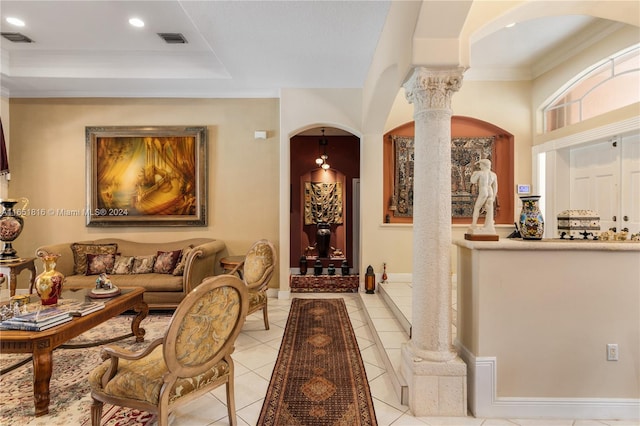 tiled living room featuring crown molding and ornate columns