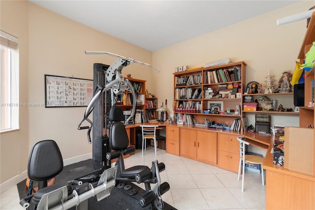 exercise room with light tile patterned floors