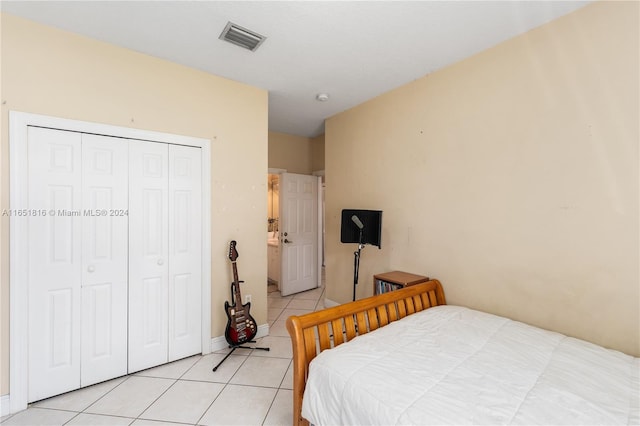 bedroom with a closet and light tile patterned floors