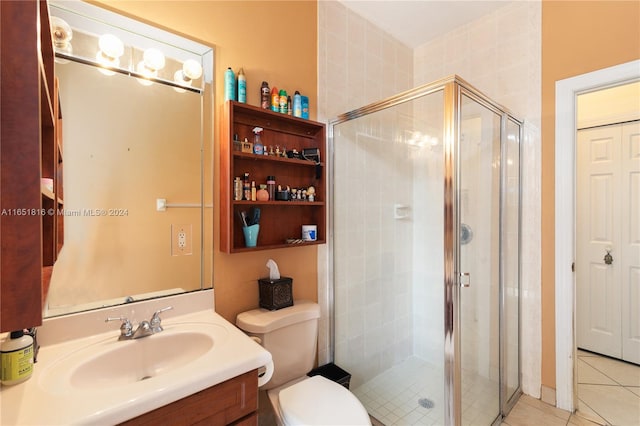 bathroom featuring tile patterned floors, a shower with shower door, vanity, and toilet