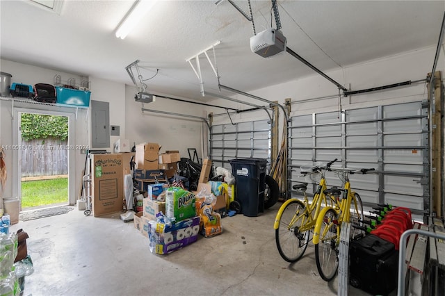 garage with a garage door opener and electric panel