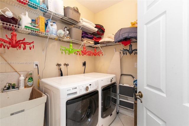 washroom with washer and clothes dryer, sink, and tile patterned floors