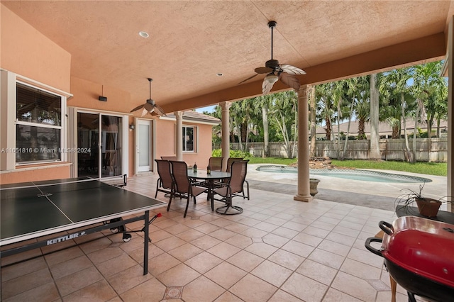 view of patio with ceiling fan and a fenced in pool