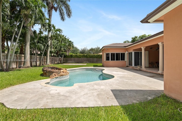 view of swimming pool featuring a lawn and a patio