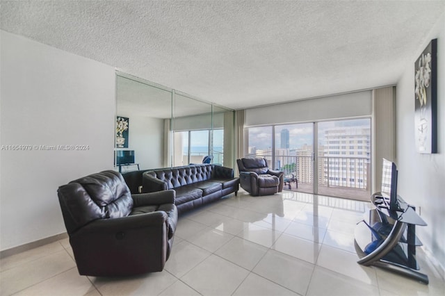 tiled living room featuring a textured ceiling