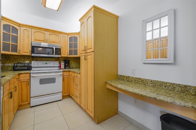 kitchen featuring light stone counters, light tile patterned floors, white electric range oven, and decorative backsplash