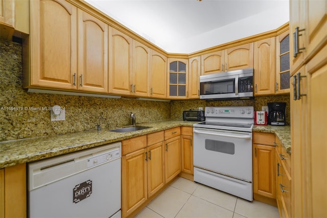 kitchen featuring light tile patterned floors, white appliances, light stone countertops, sink, and decorative backsplash