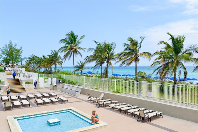 view of swimming pool with a water view and a patio