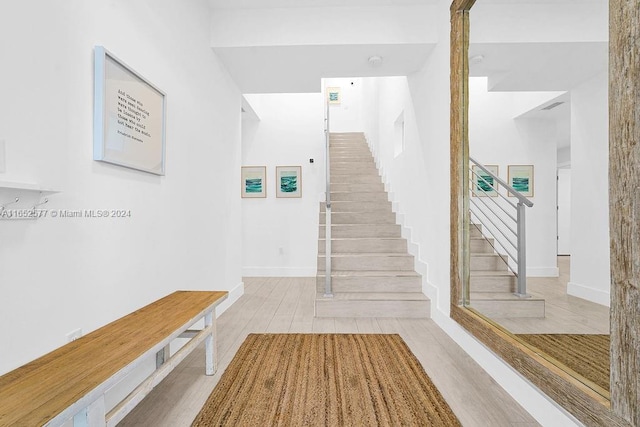 staircase with hardwood / wood-style flooring