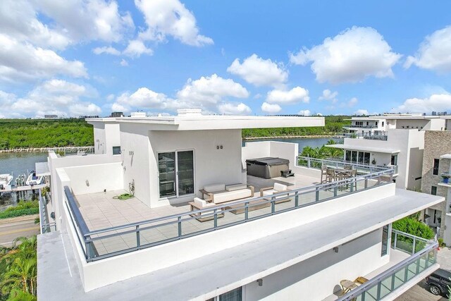 exterior space featuring a balcony and a water view