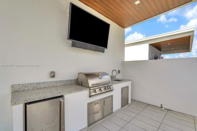 view of patio with sink and area for grilling