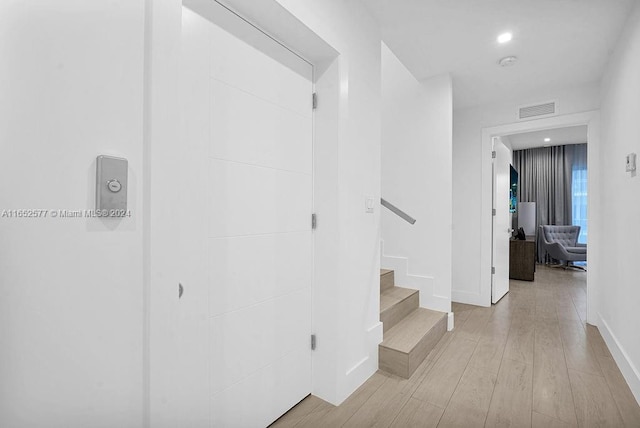 348 Desoto St, Hollywood, FL 33019 - hall with visible vents, baseboards, stairs, recessed lighting, and light wood-style floors