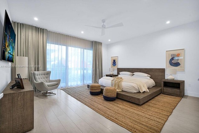 bedroom featuring light wood-type flooring and ceiling fan