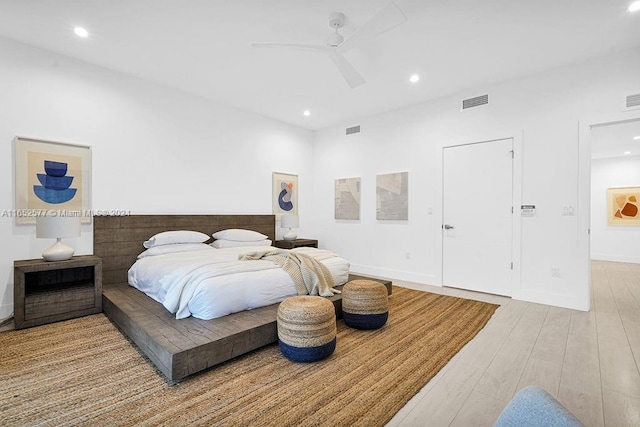 bedroom with ceiling fan and light hardwood / wood-style floors