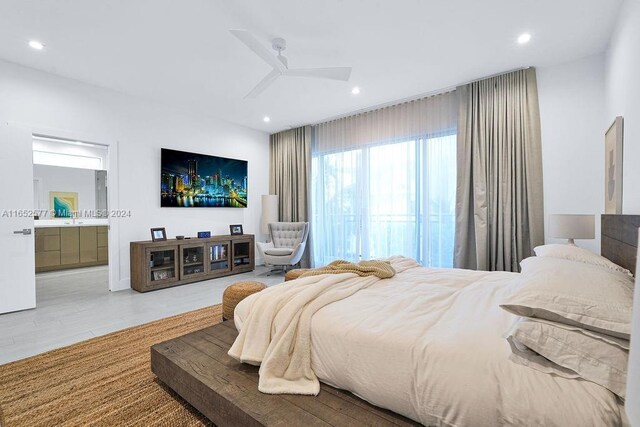 bedroom featuring ceiling fan, ensuite bathroom, and sink