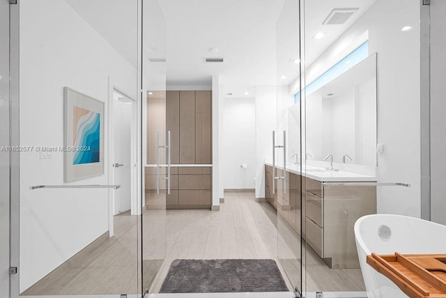 348 Desoto St, Hollywood, FL 33019 - full bathroom with visible vents, recessed lighting, a freestanding bath, and vanity