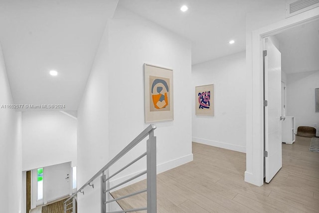 348 Desoto St, Hollywood, FL 33019 - hall featuring wood finished floors, visible vents, baseboards, recessed lighting, and an upstairs landing