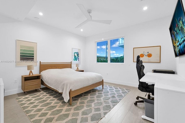 bedroom with ceiling fan and light wood-type flooring