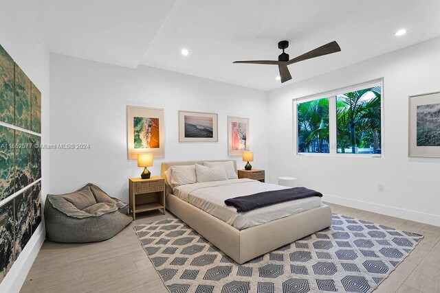 bedroom featuring light wood-type flooring and ceiling fan