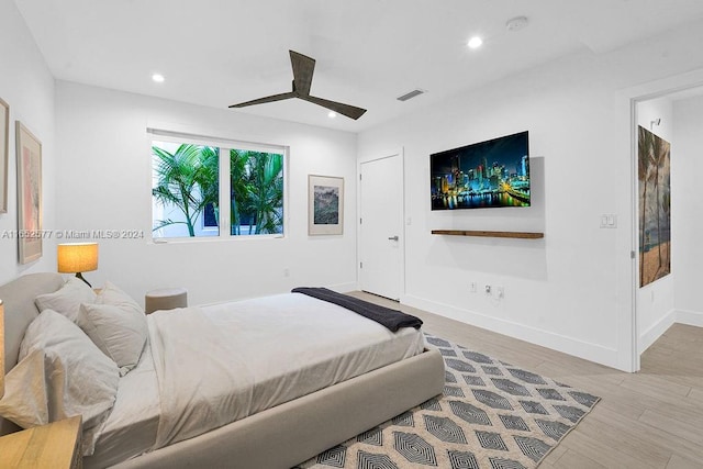 bedroom with light hardwood / wood-style flooring and ceiling fan