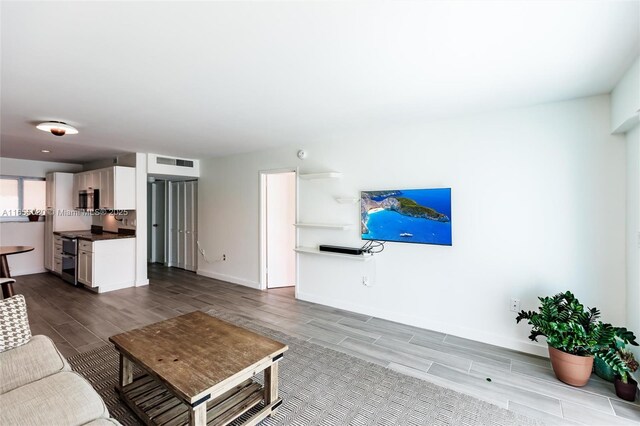 living room with a water view and wood-type flooring