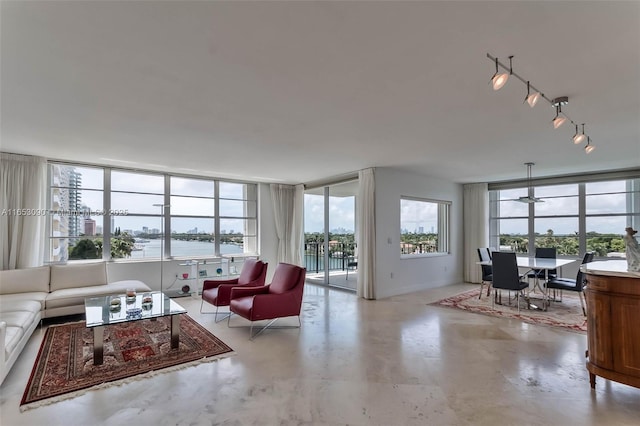 living room with a water view and track lighting