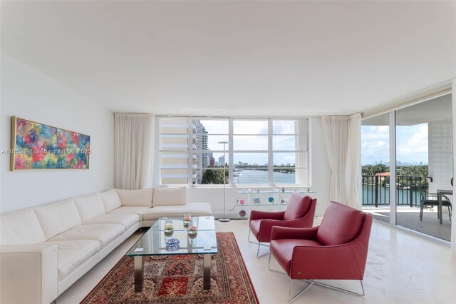 living room with a water view and a wall of windows