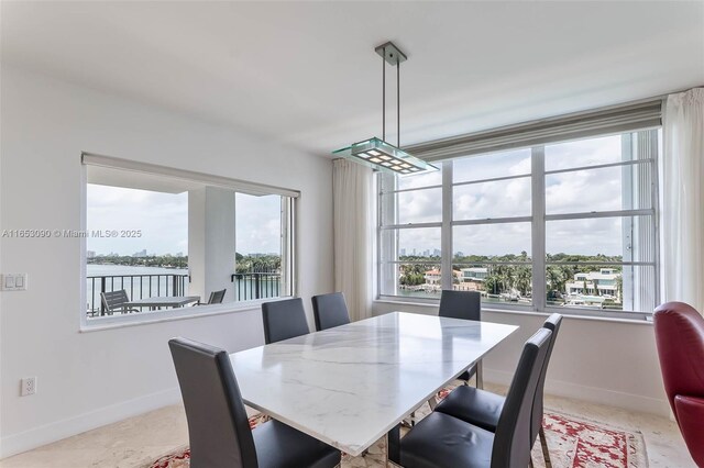 dining area featuring a water view