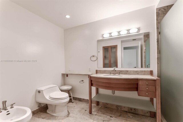 bathroom featuring a bidet, toilet, and sink