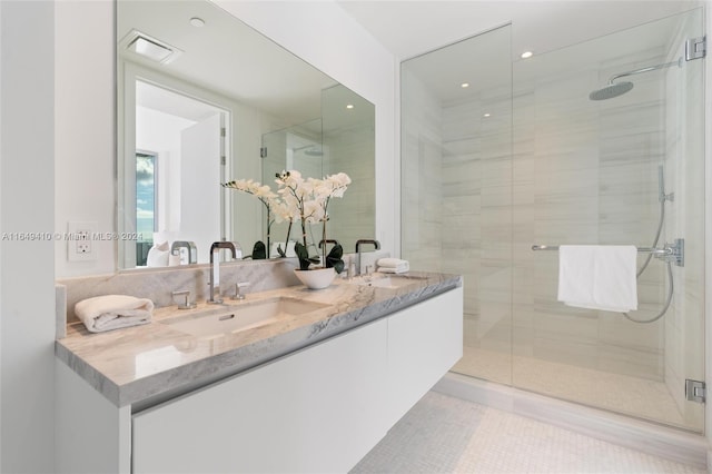 bathroom with walk in shower and vanity