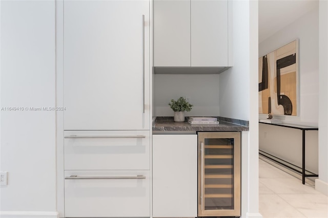 bar featuring wine cooler, light tile patterned floors, and white cabinets