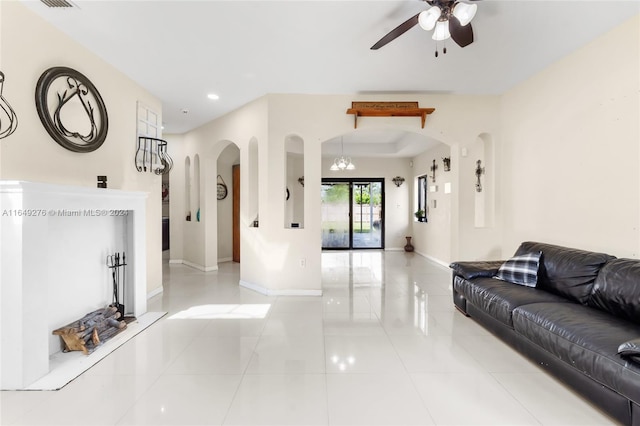 tiled living room with ceiling fan