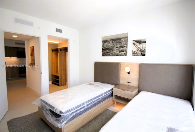 tiled bedroom with a closet