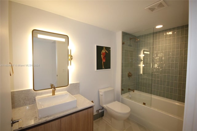 full bathroom featuring tile patterned flooring, vanity, toilet, and tiled shower / bath