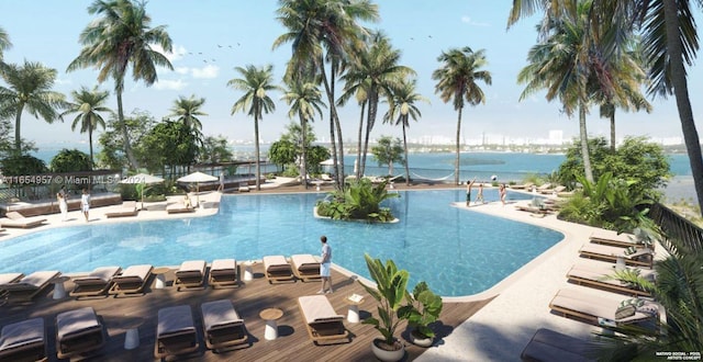 view of pool featuring a patio and a water view