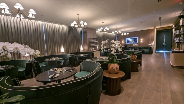 dining area with hardwood / wood-style flooring and a notable chandelier