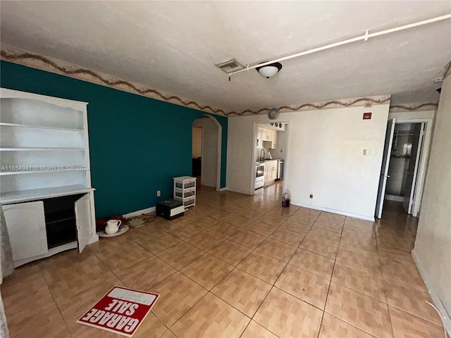 unfurnished living room featuring light tile patterned floors