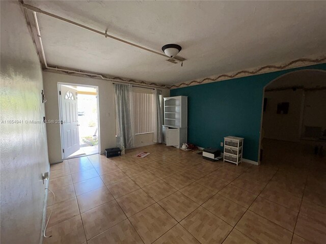 unfurnished room with light tile patterned floors