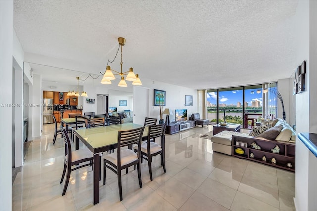 tiled dining area with expansive windows, a textured ceiling, and a notable chandelier