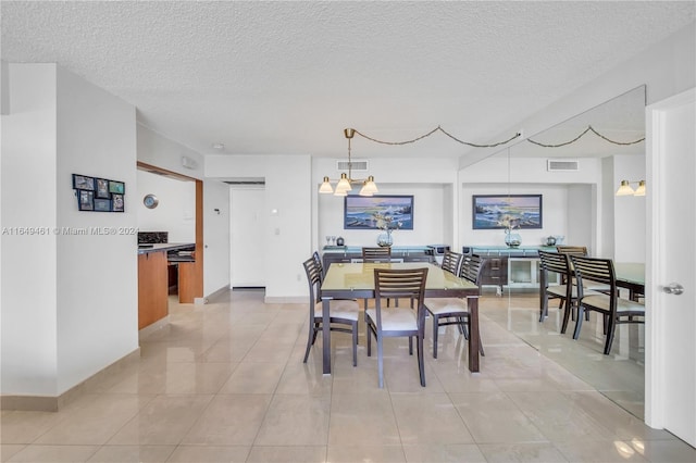 tiled dining space featuring a textured ceiling