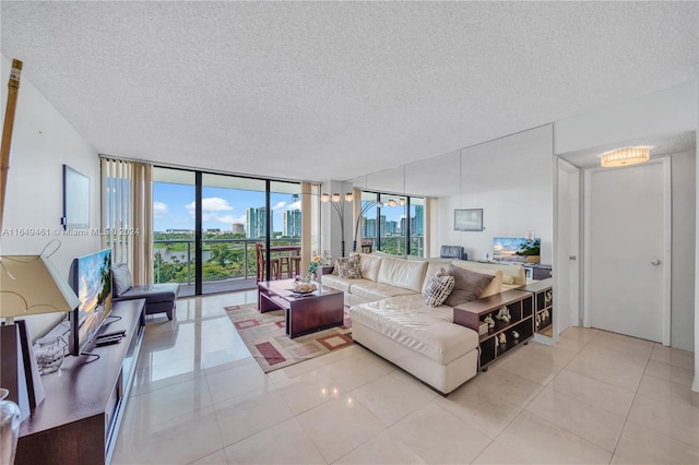 living room with expansive windows, light tile patterned flooring, and a textured ceiling