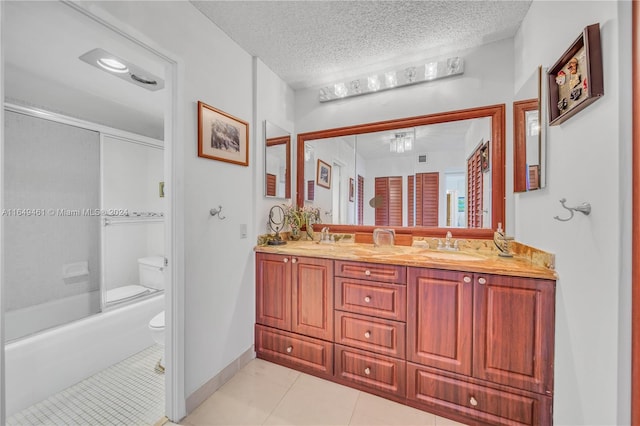 full bathroom with tile patterned floors, bath / shower combo with glass door, a textured ceiling, toilet, and vanity