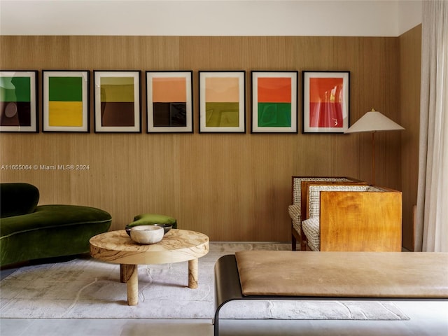 sitting room featuring wooden walls